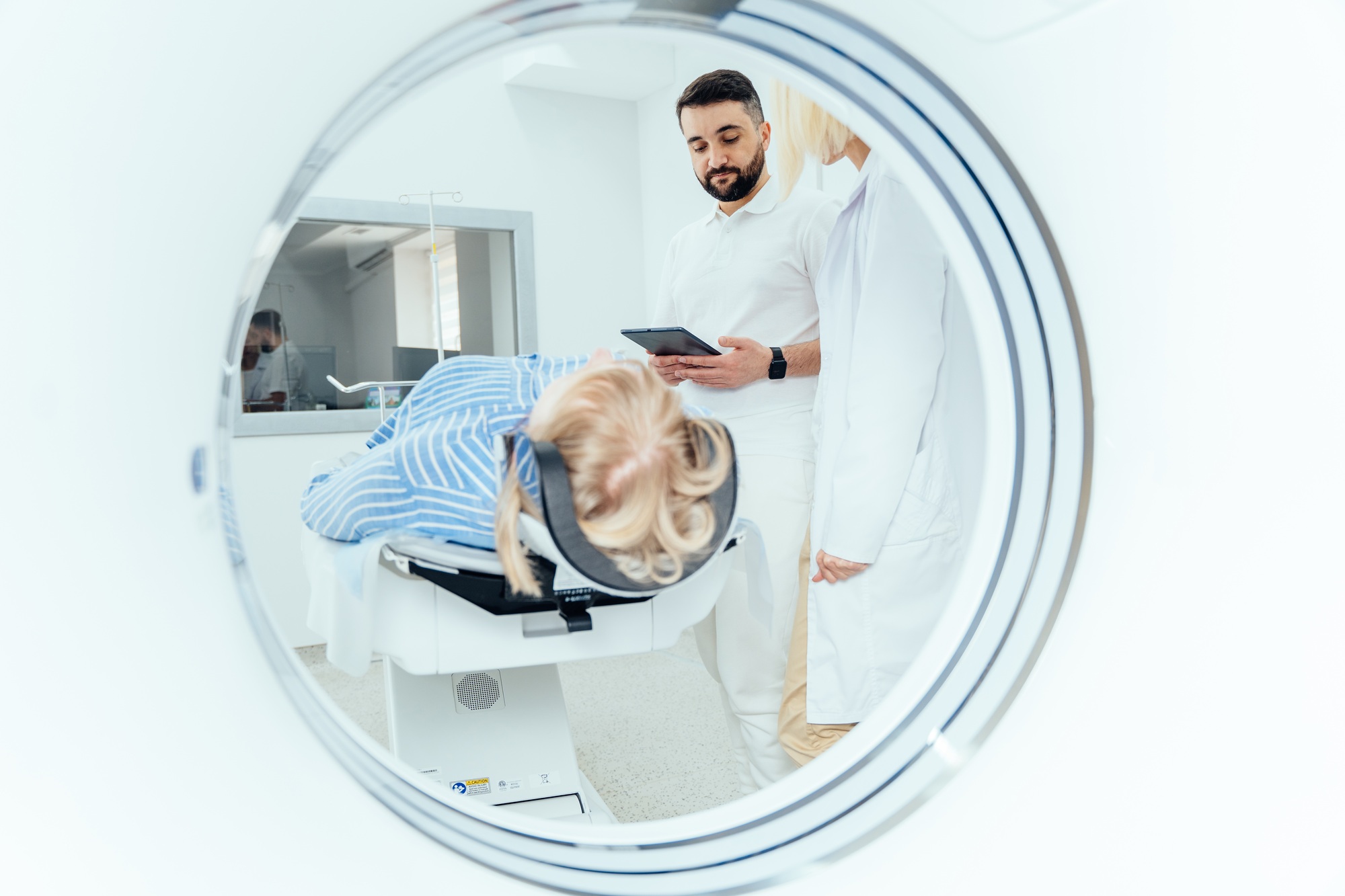 Radiographer operating computed tomography scanner
