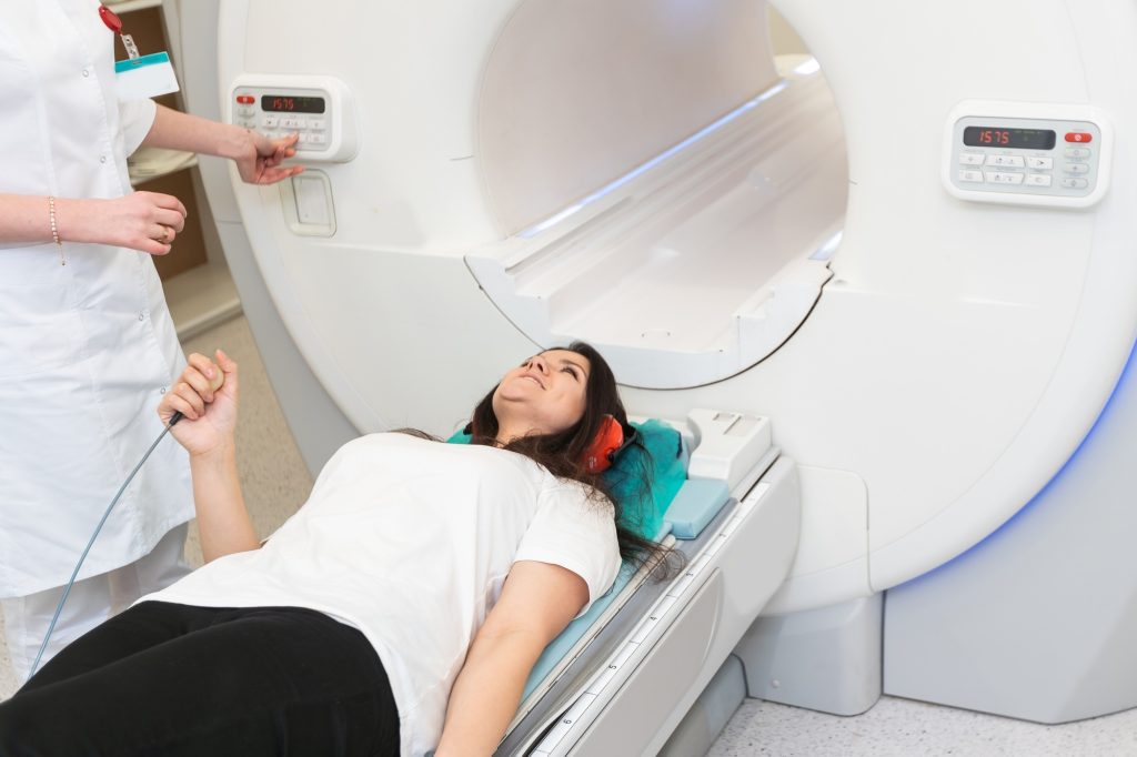 Female patient undergoing MRI - Magnetic resonance imaging in Hospital. Medical Equipment and Health